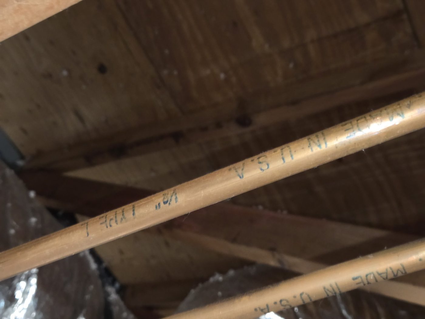 Original half-inch Type L copper water line in a 1971 Naples house, clean on the visible side