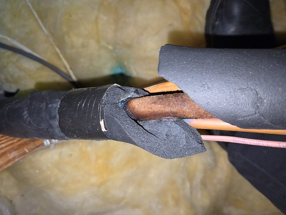 Broken insulation on an air conditioner suction line in a Naples attic exposing bare copper that sweats in the heat