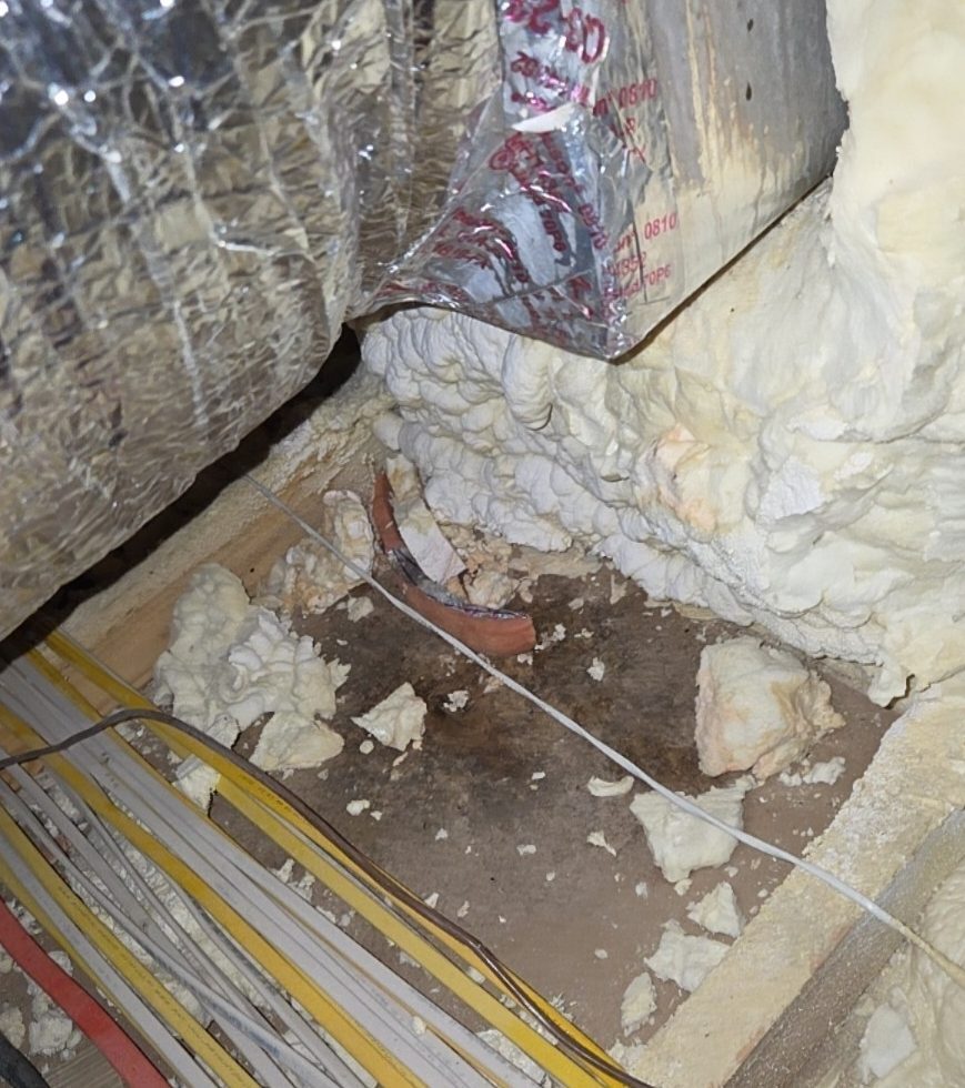 Attic HVAC ductwork with mold growth on the surfaces below it in a new-construction home