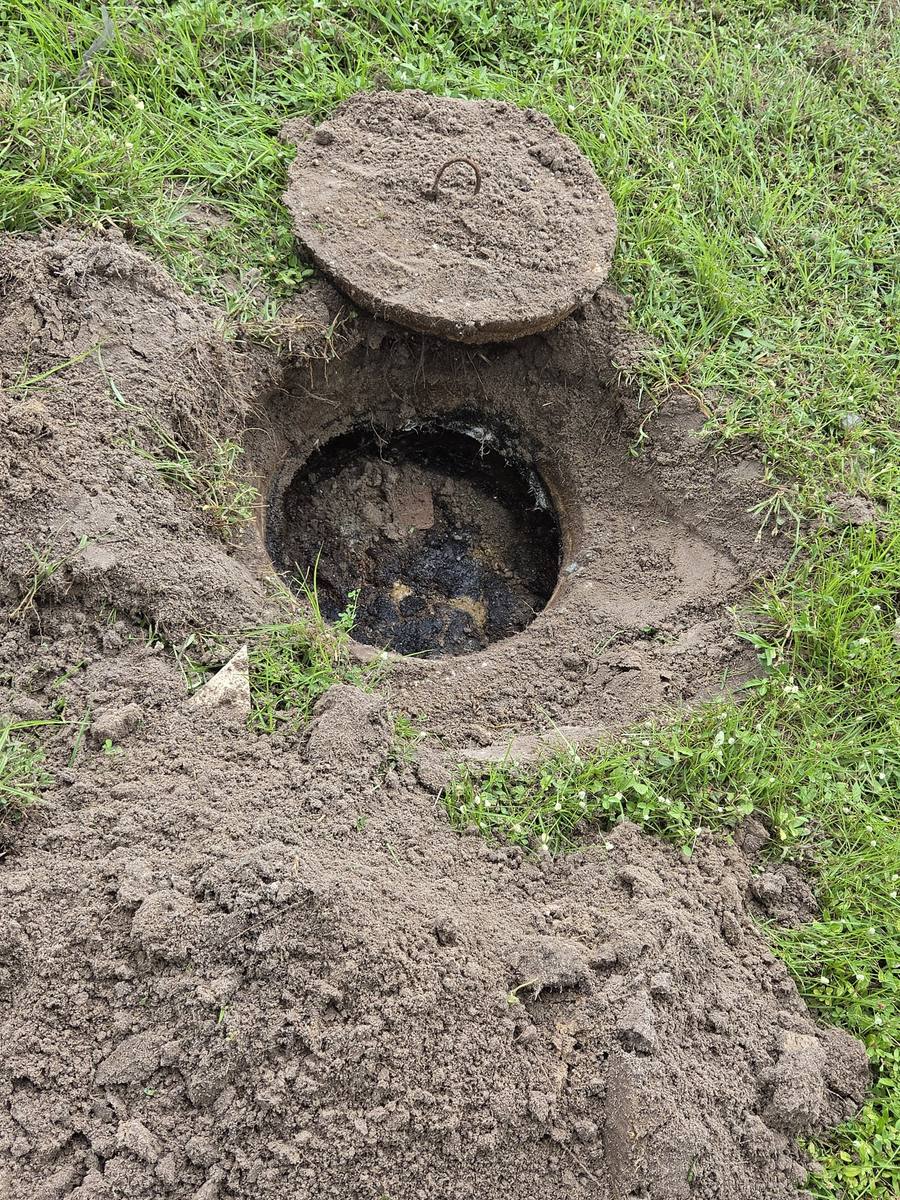 Septic tank inlet lid opened showing the liquid level during a pump-out inspection in Lehigh Acres