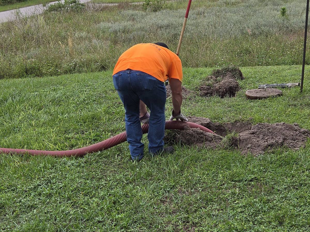 Septic tank lid removed and outlet filter pulled during a Lehigh Acres septic inspection